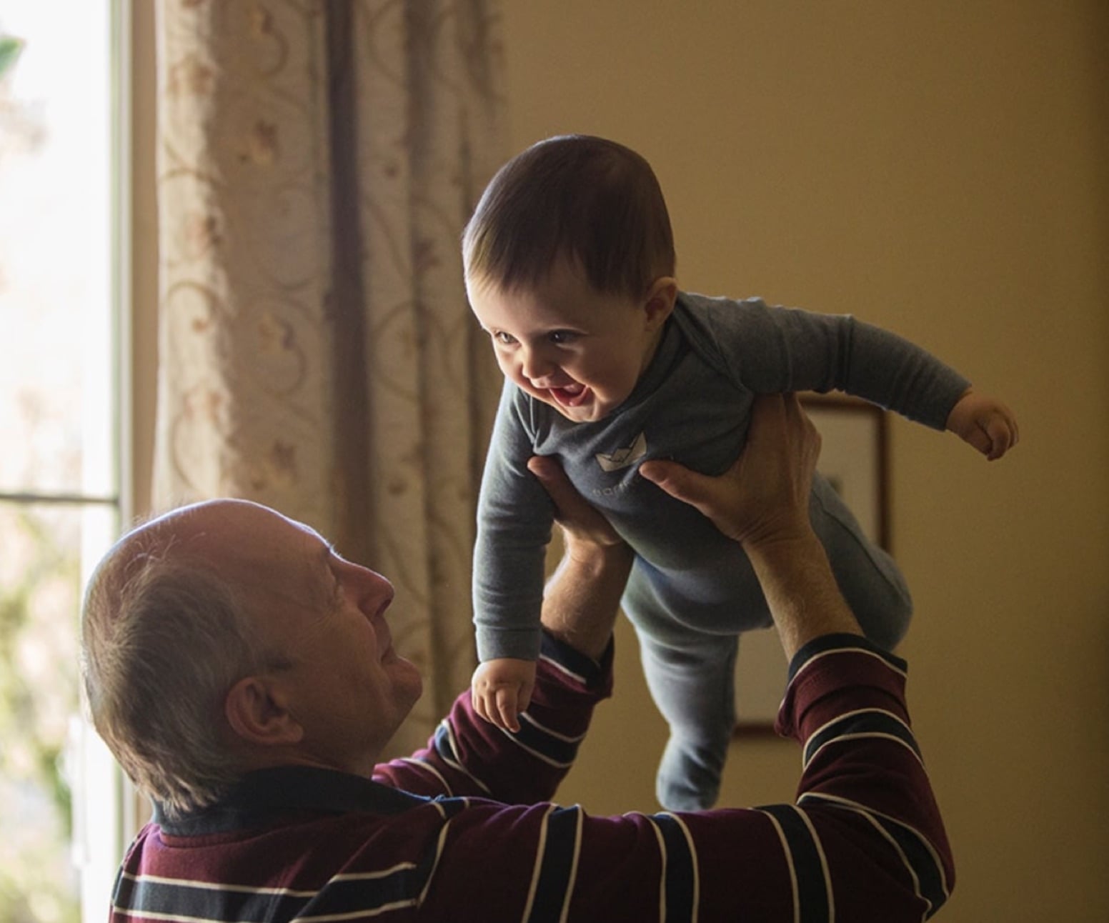 man holding a smiling baby